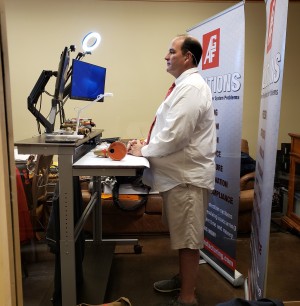 Jim presenting a webinar in a button-up shirt and tie in the camera's view and pair of shorts below the camera's view.